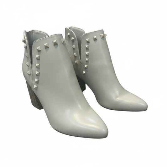 Pair of light gray ankle boots with studded details.